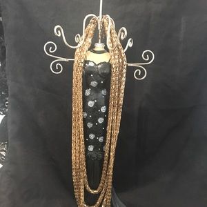 Goldish long roped necklace.